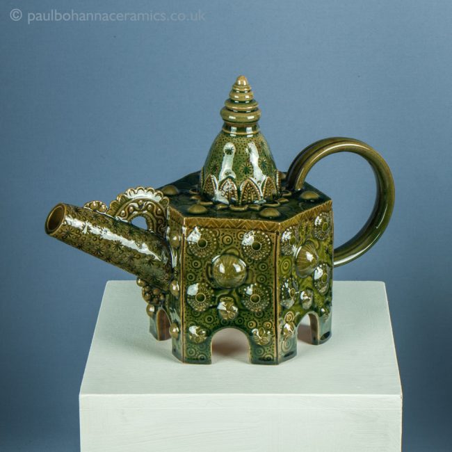 Hexagonal teapot. Green lead glazed with oxides. PB050. Obverse on plinth.